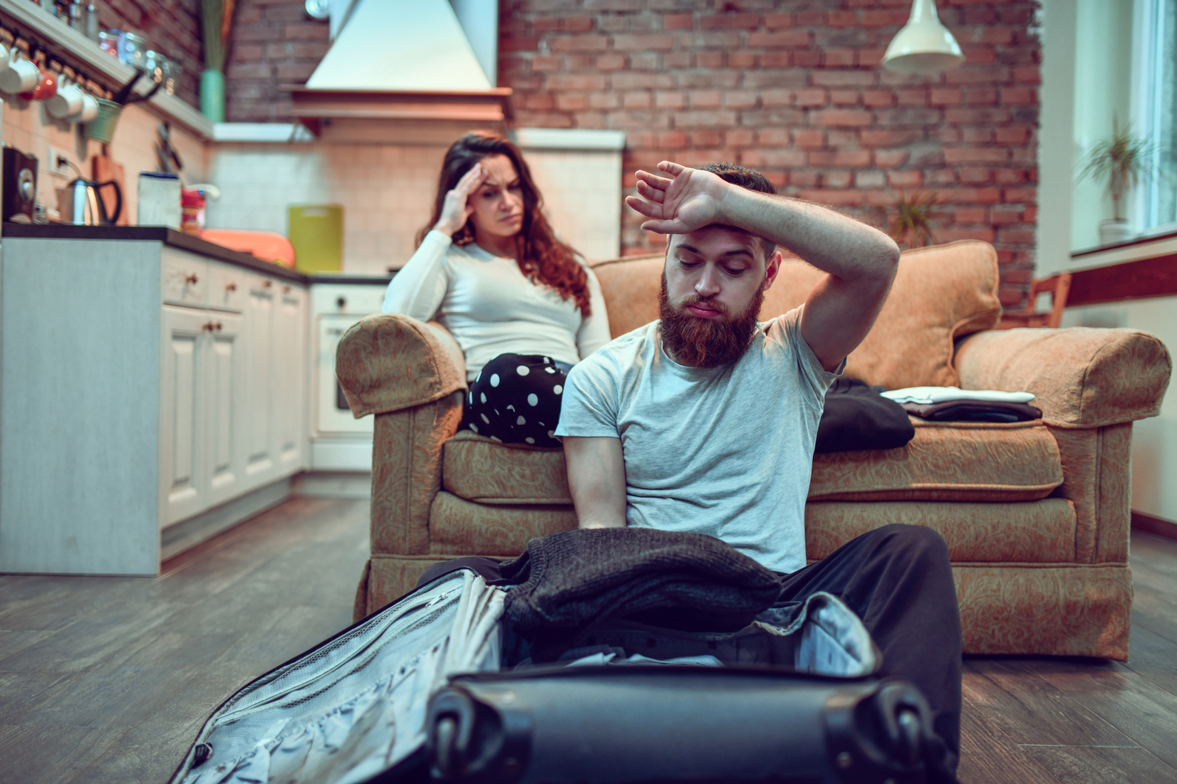 Couple Stressed While Packing For Trip